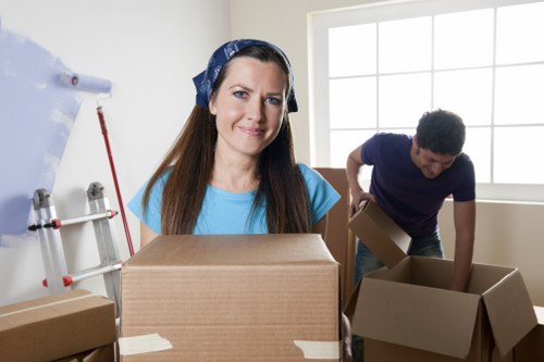Professional movers loading furniture into a removal van in Cowley